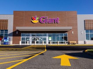 Giant foods, store front with large yellow direction arrow pointing towards the store.
