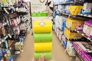 hand holding a pack of dog waste bags