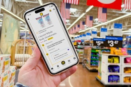 hand holding smartphone with 1-clip in walmart store