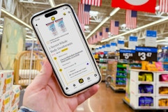 hand holding smartphone with 1-clip in walmart store