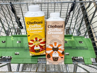 Two bottles of Chobani coffee creamer in a grocery cart