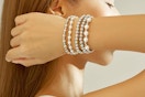 Still shot of the Wgoud Silver 5-Piece Bracelet Set worn by a woman.