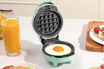 SUNVIVIPRO 6 in 1 Mini Waffle Maker making a single egg.