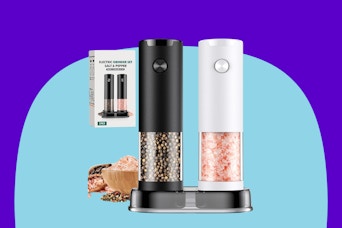 An electric salt grinder in white and pepper grinder in black. Both are clear half the way up. Some food and a box sit or float behind them