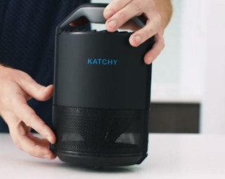 Hands holding an indoor fly trap