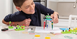subscription boxes for kids - A kid working on a project from an Annie's Kit Club genius subscription box
