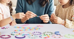 a mom and daughters making beaded bracelets