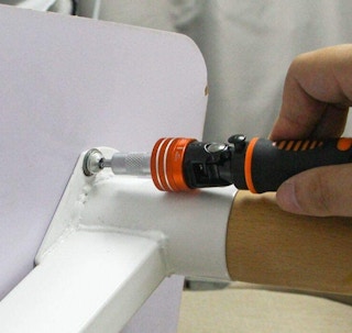 a screwdriver fixing a table's leg