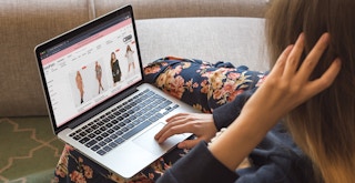 A person using a laptop to shop on the Boohoo website