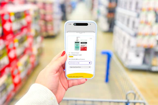 hand holding a smartphone displaying a 1-clip coupon in the kcl app