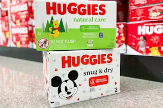 Huggies natural care wipes + snug & dry diapers value boxes stacked in diaper isle on floor in Target store