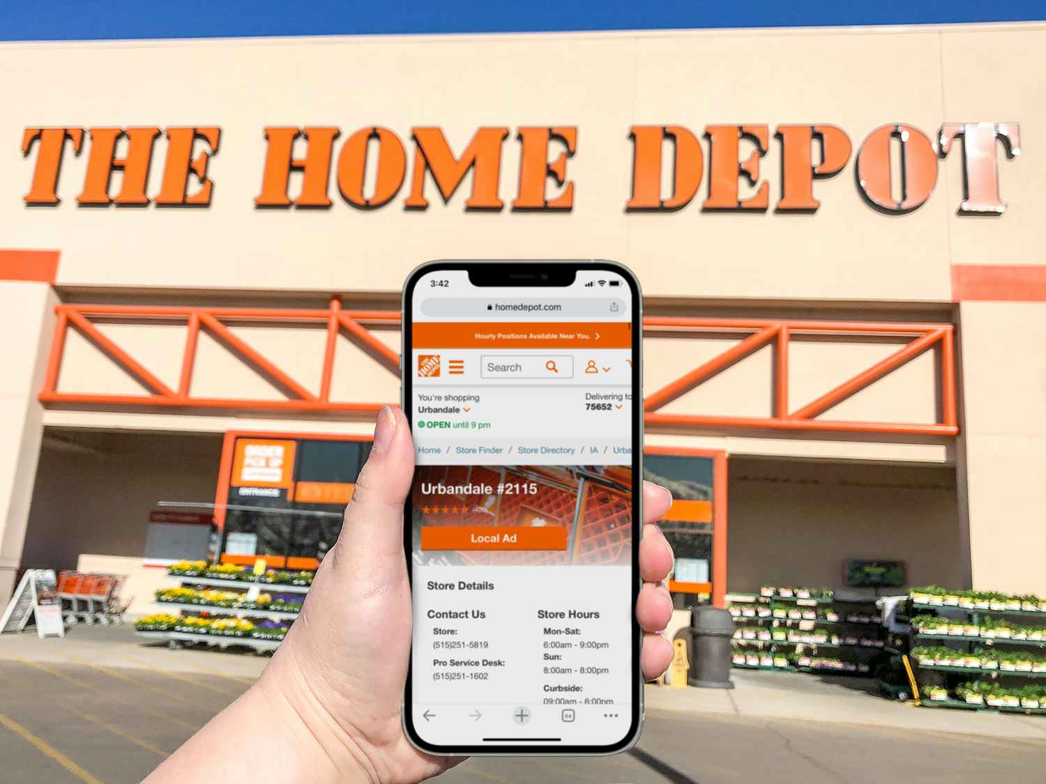 person in front of home depot store holding phone with website