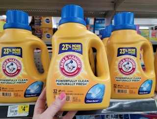 hand holding a bottle of arm hammer laundry detergent