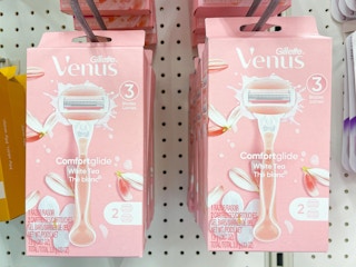 multiple Venus White Tea razors hanging from a store rack.