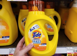 hand holding a bottle of tide simply detergent