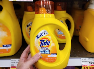hand holding a bottle of tide simply detergent