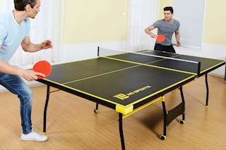 Lifestyle image of the MD Sports Indoor Table Tennis Pong Table being played with by two adults
