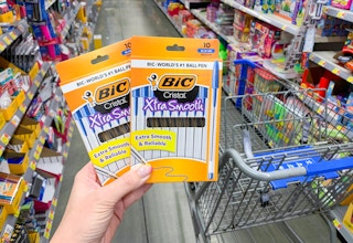 two boxes of bic cristal xtra smooth pens held up in front of other pens