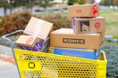 a KCL themed cart filled with shipping boxes from different retailers