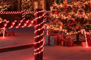 candy cane ropes around a fence outside a house