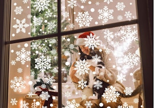 116PCS Christmas Decorations, 9 Sheets Christmas Window Clings on a window.