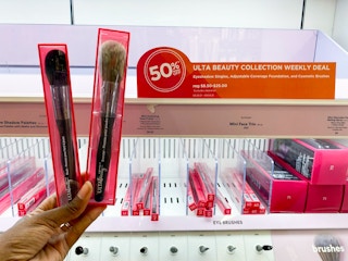 hand holding makeup brushes