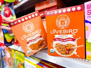 hand holding a box of lovebird cereal on walmart shelf