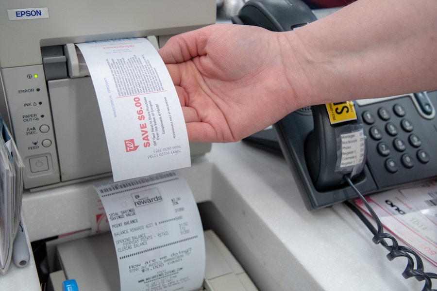 Register Rewards coming out of a machine at a Walgreens register.