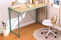 Lifestyle image of the Mainstays Folding Desk in "Sage Green"