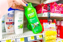 hand grabbing a bottle of pert shampoo
