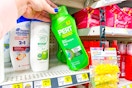 hand grabbing a bottle of pert shampoo