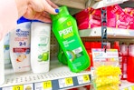 hand grabbing a bottle of pert shampoo