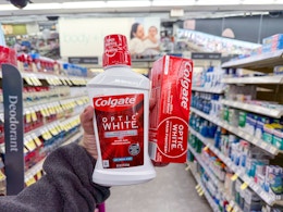 hand holding colgate oral care items in walgreens