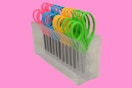 a pack of scissors on a pink background