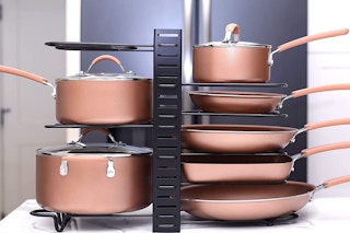 Black pot organizer with rose gold pans on a counter