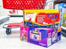 2 bounce houses sitting in front of a parked target cart