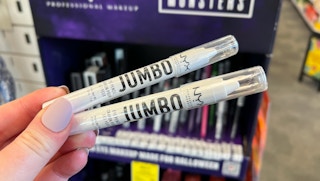 hand holding two eyeliners