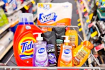 scott toilet paper, tide detergent, axe body wash, garner whole blends shampoo, and dial soap in a cart