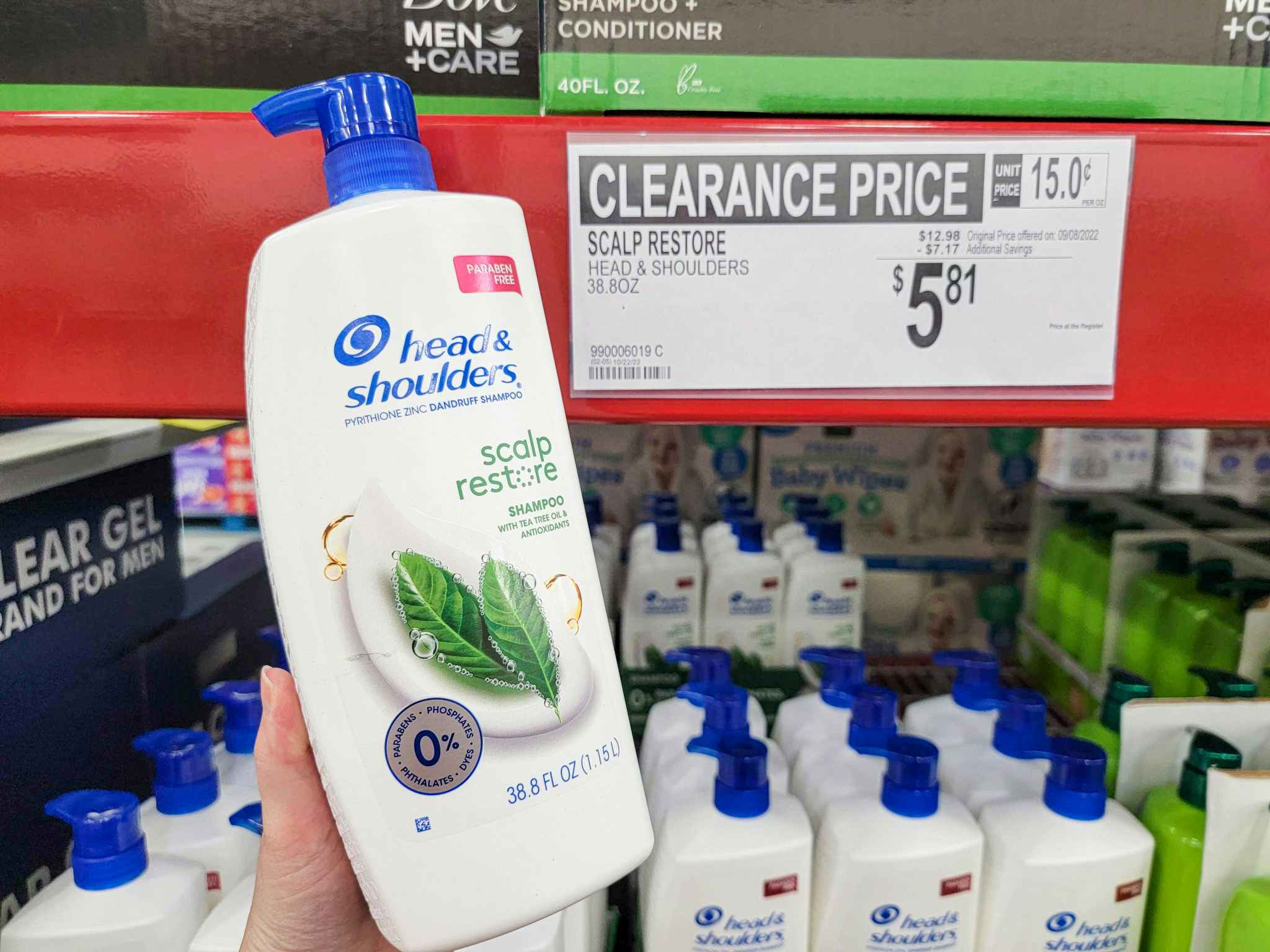 hand holding a bottle of head & shoulders by a sign for 5.81