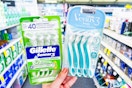 hand holding two packs of razors