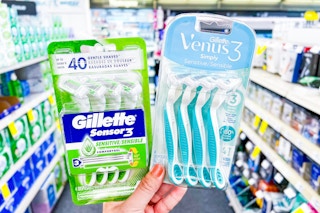 hand holding two packs of razors