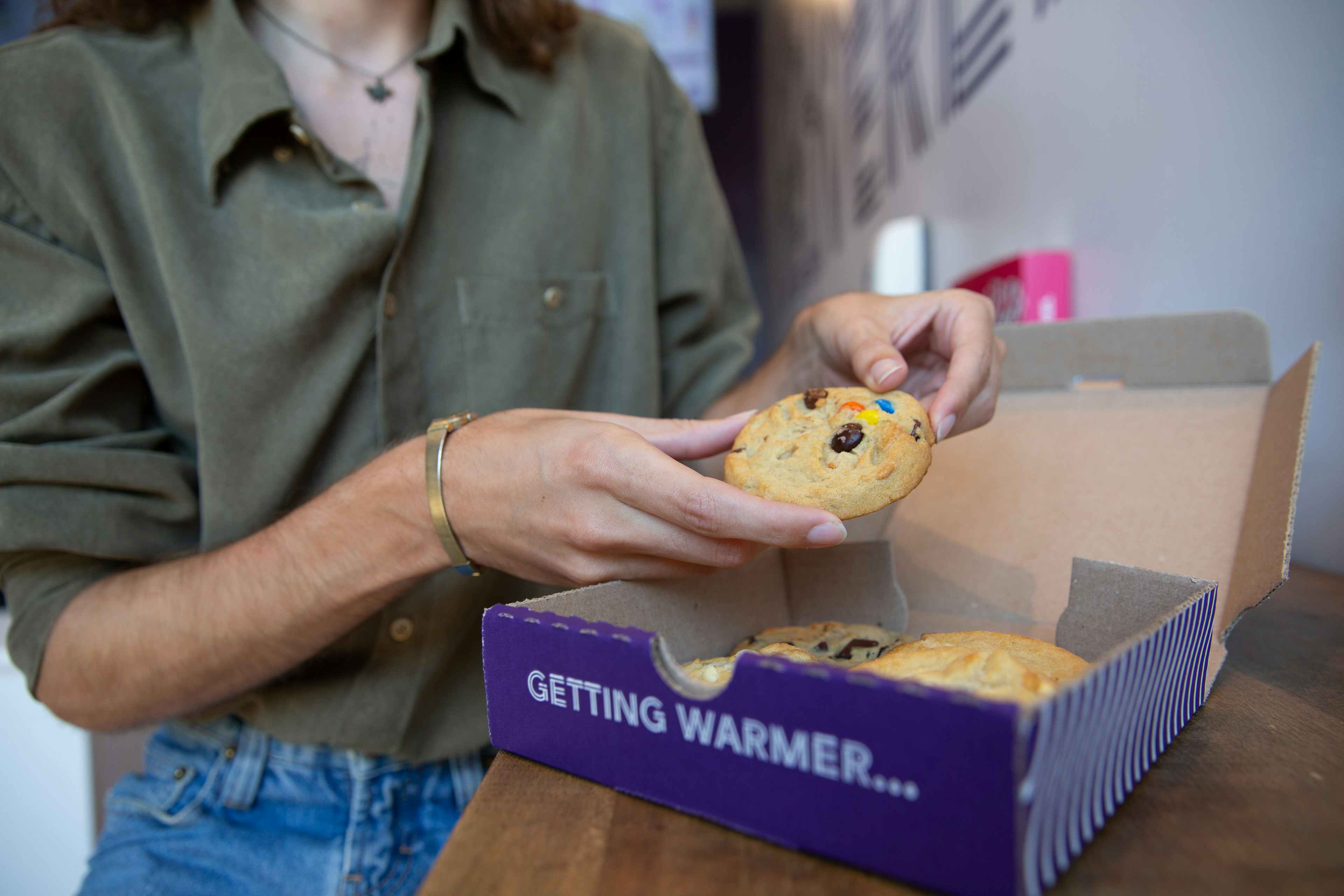 person holding some cookies from insomnia cookies