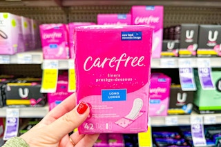 person holding a package of carefree panty liners
