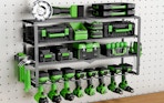 a power tool organizer on a wall with green and black tools