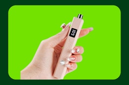 hand holding nail lamp on template