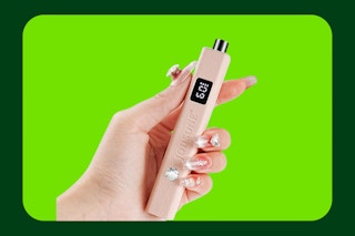 hand holding nail lamp on template