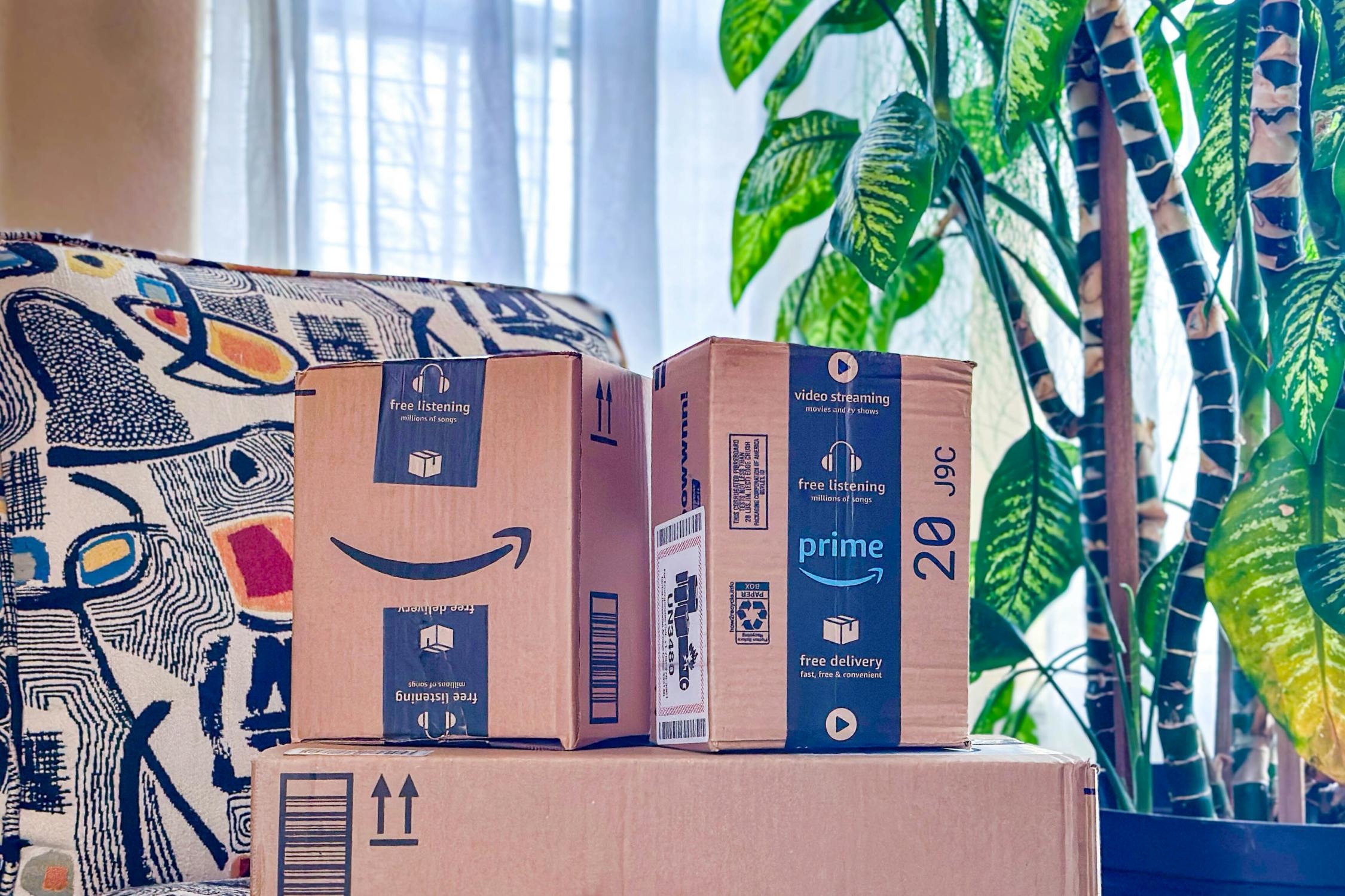 person picking up amazon box