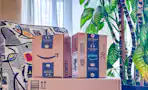 person picking up amazon box