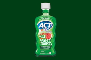 a green bottle of mouthwash and tube of toothpaste