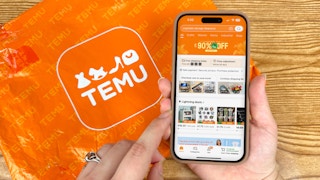 Someone looking at the Temu app with a Temu package in the background